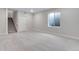 Finished basement with carpeted floors, a window well, and a staircase to the upper level at 10661 Reunion Pkwy, Commerce City, CO 80022