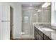 Bright bathroom showcases a glass-enclosed shower with a gray tiled surround at 10661 Reunion Pkwy, Commerce City, CO 80022