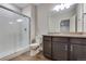 Bathroom features a modern vanity with gray counters and separate glass enclosed shower at 10661 Reunion Pkwy, Commerce City, CO 80022