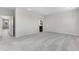 Empty bedroom with light gray carpet and view to en suite bathroom at 10661 Reunion Pkwy, Commerce City, CO 80022