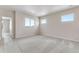 Cozy bedroom featuring neutral carpet and multiple windows for natural light at 10661 Reunion Pkwy, Commerce City, CO 80022
