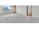 Spacious bedroom with neutral carpeting and a large window with neighborhood views at 10661 Reunion Pkwy, Commerce City, CO 80022