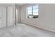 Well-lit bedroom featuring soft carpet, large window and closet with sliding doors at 10661 Reunion Pkwy, Commerce City, CO 80022