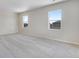 Primary bedroom with neutral carpeting and two windows allowing lots of natural light at 10661 Reunion Pkwy, Commerce City, CO 80022