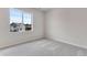 Bright bedroom featuring soft carpet and a large window with outside views at 10661 Reunion Pkwy, Commerce City, CO 80022
