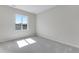 Simple bedroom with soft carpet and a window highlighting the architecture of the neighborhood at 10661 Reunion Pkwy, Commerce City, CO 80022