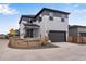 View of the house featuring an attached two car garage and fenced yard at 10661 Reunion Pkwy, Commerce City, CO 80022