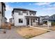 Charming two-story home featuring a covered front porch and modern gray and white color scheme at 10661 Reunion Pkwy, Commerce City, CO 80022