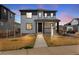Charming two-story home featuring a covered front porch and modern gray and white color scheme at 10661 Reunion Pkwy, Commerce City, CO 80022