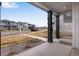 Covered front porch with dark wood pillars, offering a view of the neighborhood at 10661 Reunion Pkwy, Commerce City, CO 80022