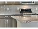 Close-up view of the speckled granite countertop in a kitchen with gray cabinets at 10661 Reunion Pkwy, Commerce City, CO 80022