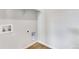 Laundry room includes connections for washer and dryer, shelving and wood look flooring at 10661 Reunion Pkwy, Commerce City, CO 80022