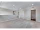 Open-concept living area with neutral carpet and multiple windows allowing light at 10661 Reunion Pkwy, Commerce City, CO 80022