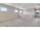 Spacious living area with neutral carpet and large windows allowing natural light at 10661 Reunion Pkwy, Commerce City, CO 80022