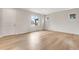 Bright living room with wood floors and a large window at 10661 Reunion Pkwy, Commerce City, CO 80022
