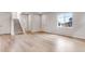 Spacious living room featuring hardwood floors, stairs, and natural light at 10661 Reunion Pkwy, Commerce City, CO 80022