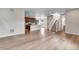 Open concept living room featuring wood flooring and staircase at 10661 Reunion Pkwy, Commerce City, CO 80022