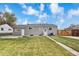 Spacious backyard featuring a well-maintained lawn, a patio, and a privacy fence at 1182 S Alcott St, Denver, CO 80219