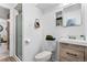 Clean bathroom with a glass shower, a modern vanity, and a toilet with minimalist design at 1182 S Alcott St, Denver, CO 80219