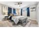 Comfortable bedroom with plush carpet, ceiling fan, a well-dressed bed, and natural light from a side window at 1182 S Alcott St, Denver, CO 80219