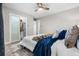 Stylish bedroom features a sliding closet door, neutral walls, soft carpet, and a comfortable bed with accent pillows at 1182 S Alcott St, Denver, CO 80219