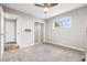 Bright bedroom featuring neutral paint, a ceiling fan, and a closet at 1182 S Alcott St, Denver, CO 80219