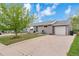 Charming one-story home with well-maintained lawn, mature tree, and driveway leading to a one-car garage at 1182 S Alcott St, Denver, CO 80219