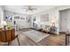 Inviting living room with modern decor, hardwood floors, neutral walls, and dining area with large window at 1182 S Alcott St, Denver, CO 80219