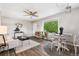 Cozy living room featuring stylish furniture, ceiling fan, hardwood floors, and natural light from a large window at 1182 S Alcott St, Denver, CO 80219