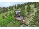 Mountain home aerial view with solar panels and lush landscape at 1575 York Gulch Rd, Idaho Springs, CO 80452