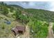Aerial view of a mountain home with solar panels and mature trees at 1575 York Gulch Rd, Idaho Springs, CO 80452