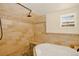 Modern bathroom with tiled walls, a relaxing soaking tub, and a bright, airy window at 1575 York Gulch Rd, Idaho Springs, CO 80452