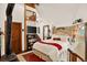 Comfortable bedroom with high ceilings, wood accents, and a cozy wood-burning stove at 1575 York Gulch Rd, Idaho Springs, CO 80452