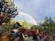 Deck with outdoor kitchen features and views of a double rainbow at 1575 York Gulch Rd, Idaho Springs, CO 80452