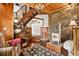 Inviting living room featuring a decorative stone wall, wood floors and a cozy wood-burning stove at 1575 York Gulch Rd, Idaho Springs, CO 80452