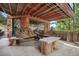 Outdoor patio with custom log seating and tree trunk coffee tables at 1575 York Gulch Rd, Idaho Springs, CO 80452