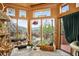 Bright sunroom with slate floors, multiple windows, and scenic outdoor views at 1575 York Gulch Rd, Idaho Springs, CO 80452