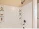 Clean, tiled bathtub and shower area with built-in shelving, showcasing the bathroom's modern design at 7292 S Blackhawk St # 2-204, Englewood, CO 80112