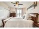 Bright bedroom with natural light, a queen-size bed, ceiling fan, and a spacious closet for ample storage at 7292 S Blackhawk St # 2-204, Englewood, CO 80112