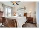 Cozy bedroom with natural light, neutral decor, a ceiling fan, and a comfortable queen-size bed at 7292 S Blackhawk St # 2-204, Englewood, CO 80112