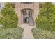 The condominium's entryway with stone archway and well-maintained landscaping at 7292 S Blackhawk St # 2-204, Englewood, CO 80112