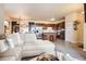 Open concept living room with kitchen, dining area, stainless steel appliances, and hardwood flooring at 7292 S Blackhawk St # 2-204, Englewood, CO 80112