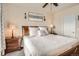 Comfortable bedroom with soft lighting, a decorative painting, and matching nightstands at 7292 S Blackhawk St # 2-204, Englewood, CO 80112