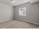 Neutral-toned bedroom with carpet, window, and electrical outlets on the walls at 265 Calhoun Cir, Castle Rock, CO 80104