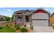 Beautiful home featuring stone accents, neutral siding, and a well-manicured front yard at 265 Calhoun Cir, Castle Rock, CO 80104