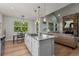 Kitchen island with gas cooktop next to breakfast nook with views of the exterior at 265 Calhoun Cir, Castle Rock, CO 80104