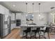 Modern kitchen featuring stainless steel appliances, granite countertops, and a breakfast bar with pendant lighting at 265 Calhoun Cir, Castle Rock, CO 80104
