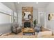 Inviting living room featuring a stone fireplace, comfortable chairs, and ample natural light at 265 Calhoun Cir, Castle Rock, CO 80104