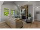 Bright living room with a stone fireplace, vaulted ceilings, and large windows overlooking a green yard at 265 Calhoun Cir, Castle Rock, CO 80104