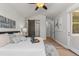 Vaulted ceiling bedroom features a decorative tray with wine set on a cozy bed, plus doors to the outside at 265 Calhoun Cir, Castle Rock, CO 80104